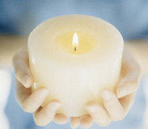 Hands Holding a Lit Candle